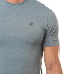 TravisMathew Scenic Vista Active Tee -Elite Golf Shop travismathew scenic vista active tee heather copen blue logo itempicture